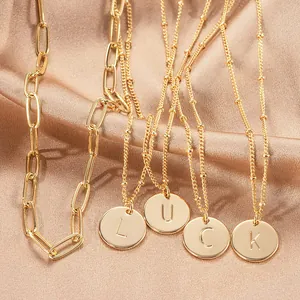 Double-layer gold paperclip necklace featuring circular initial lucky letter pendants
