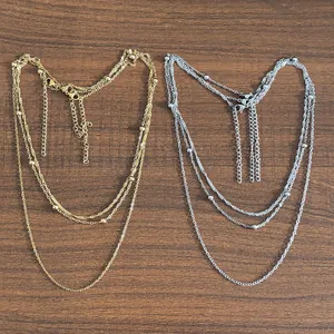 Elegant multi-layer stainless steel necklace in gold and silver finish with bead accents