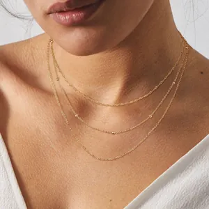 Three-layer gold stainless steel necklace with delicate bead details and twisted chain