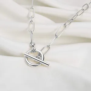 Detailed view of silver paperclip chain necklace with high-polish toggle clasp on satin