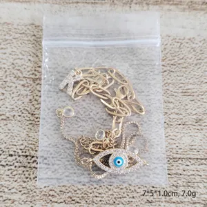 Gouden armbandset met Evil Eye en letter K hanger met zirkonia en blauw emaille detail
