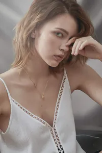 Golden stainless steel letter C pendant necklace displayed on a model's neck