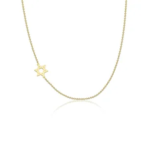 Detail view of a dainty gold-plated star of david necklace with a polished finish