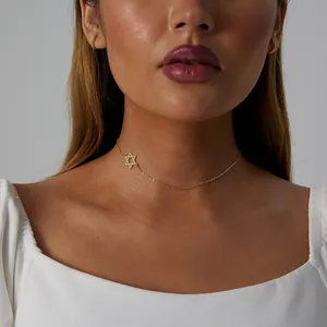 Close-up of a gold stainless steel Star of David choker necklace on a model's neck