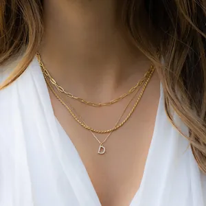 Close-up of gold layered paperclip chain necklace with zircon D letter pendant