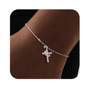 Close-up of sparkling 18K silver bracelet featuring a zircon-encrusted cross pendant