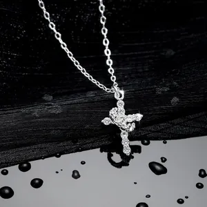 Macro detail of silver cross pendant with 3A zircon pavé setting and twist detail