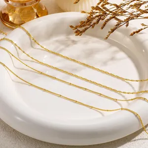 Detailed close-up of 18K gold plated stainless steel layered chains in various styles
