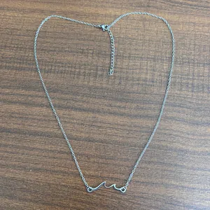 Silver stainless steel necklace with wave pendant and adjustable lobster clasp closure