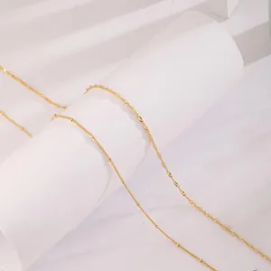 Close-up of dual-layer 18K gold-plated satellite and twisted wave body chain