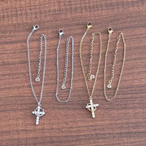 Detailed view of silver and gold cross bracelets with 3A zircon stones and lobster clasp