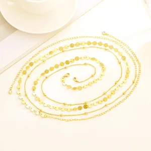 Detailed view of layered 18K gold plated beaded chains and sparkling zircon pendant