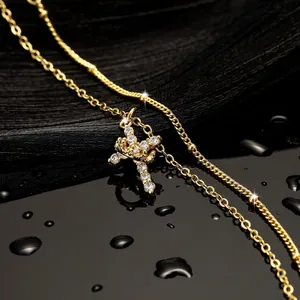 Macro view of 18K gold cross pendant necklace with sparkling AAA zircon inlay detail