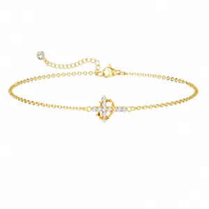 Detail of 18K gold chain bracelet with sparkling cross pendant and zircon crown accents