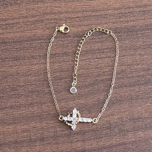 Detailed view of 18K gold double-layer crown cross bracelet with micro-pave zircons