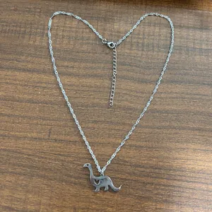 Minimalist silver stainless steel dinosaur necklace with hollow heart and adjustable chain