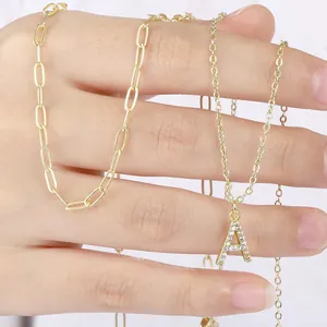Close-up of gold paperclip chain necklace with a sparkling zircon letter A pendant