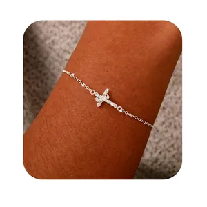 Close-up of 18K silver bracelet featuring a sparkling cross pendant with 3A cubic zirconia
