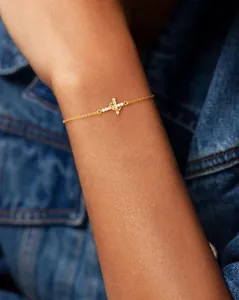 Close-up of a 18K gold-plated double-layer bracelet with sparkling cross and moon pendants