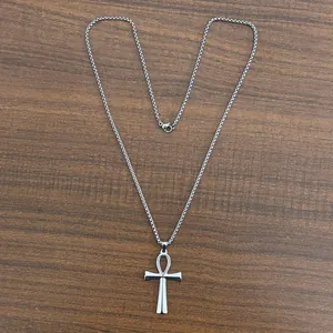 Collana con croce Ankh in argento e acciaio inossidabile con catena box su legno