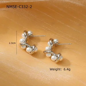 Silver twisted C-shaped earrings with pearls, 2.3cm height and 6.4g weight on gold fabric