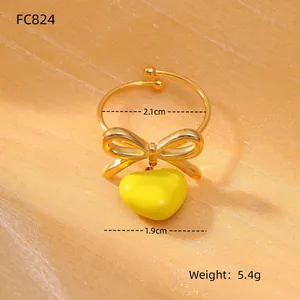 Detail view of gold bow heart ring with 2.1cm diameter and 1.9cm pendant size measurements