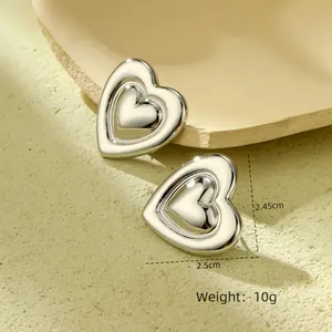 Macro shot of silver heart studs with size dimensions 2.5cm by 2.45cm and weight 10g