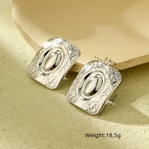 Detail view of silver vintage rectangle earrings with embossed texture and size labels