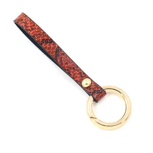 Chic faux leather keychain featuring brown snakeskin texture and golden metal spring clasp