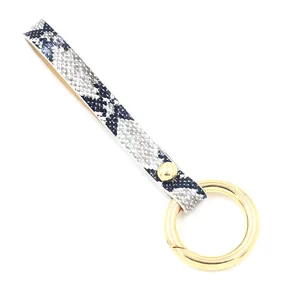 Faux snakeskin leather keychain with golden spring ring clasp and metallic rivet detail