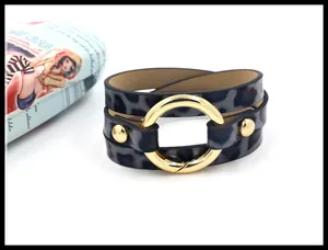 Detail eines mehrlagigen Leoparden-Lederarmbands mit großer goldener Metallschnalle