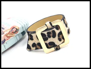 Primer plano de pulsera ancha de leopardo en pelo de pony con hebilla dorada