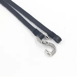 Close-up of black leather necklace with vintage silver snake hook and fine scales