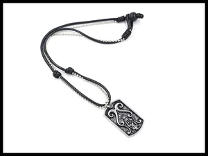 Detail of alloy pendant featuring embossed Gothic scrollwork and crown on dual chains