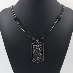 Retro rectangular dog tag necklace with baroque crown engraving on black model