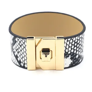 Wide faux snakeskin leather bracelet with a signature gold twist lock clasp for women