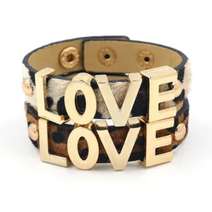 Close-up of leopard print PU leather wide bracelet with gold LOVE metal letters