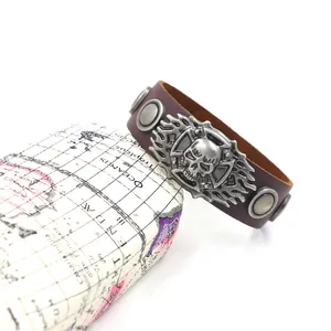 Retro punk style wide brown leather bracelet featuring skull relief and metal rivets