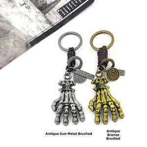 Portachiavi con mano scheletrica in bronzo e metallo antico con cuoio intrecciato