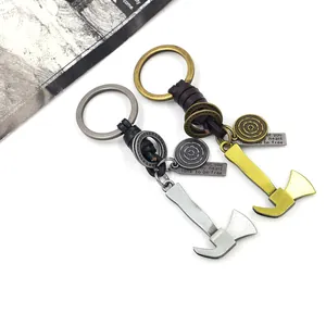 Detail of vintage axe keychains with braided leather cord and engraved quotes