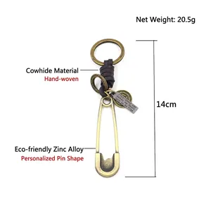Retro safety pin keychain with hand-woven brown cowhide leather strap and brass tag