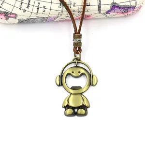 Detail of bronze headphone boy pendant with leather cord and map suitcase background