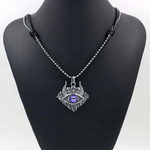 Macro detail of gothic devil eye pendant with purple resin eye and skull motifs