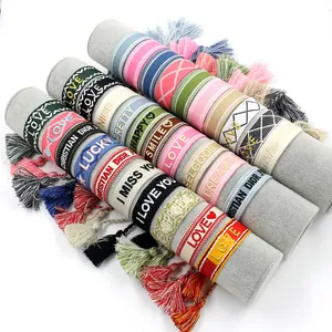 Embroidered woven tassel bracelet set featuring colorful fabric straps and patterns