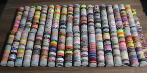 Close-up of woven wristbands with custom embroidery heart and star patterns in multi colors