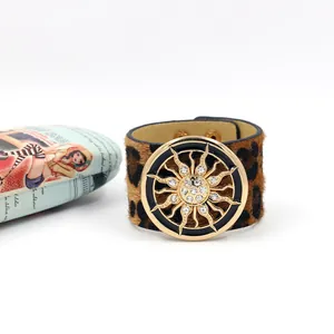 Macro detail of leopard print faux fur wide bracelet with sunburst crystal metal buckle