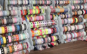 Detailed display of colorful woven bracelets with embroidery patterns and tassels
