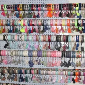 Detailed display of colorful woven friendship bracelets with LOVE and HOPE embroidery