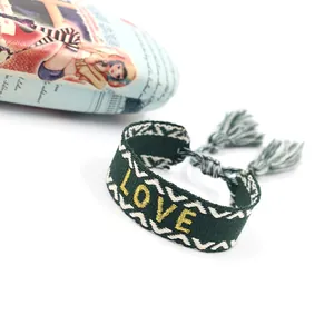 Ethnic bohemian woven bracelet with green patterns, gold LOVE embroidery and fringe