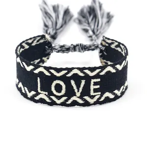 Ethnic style black woven wristband with white LOVE embroidery and fringe tassels